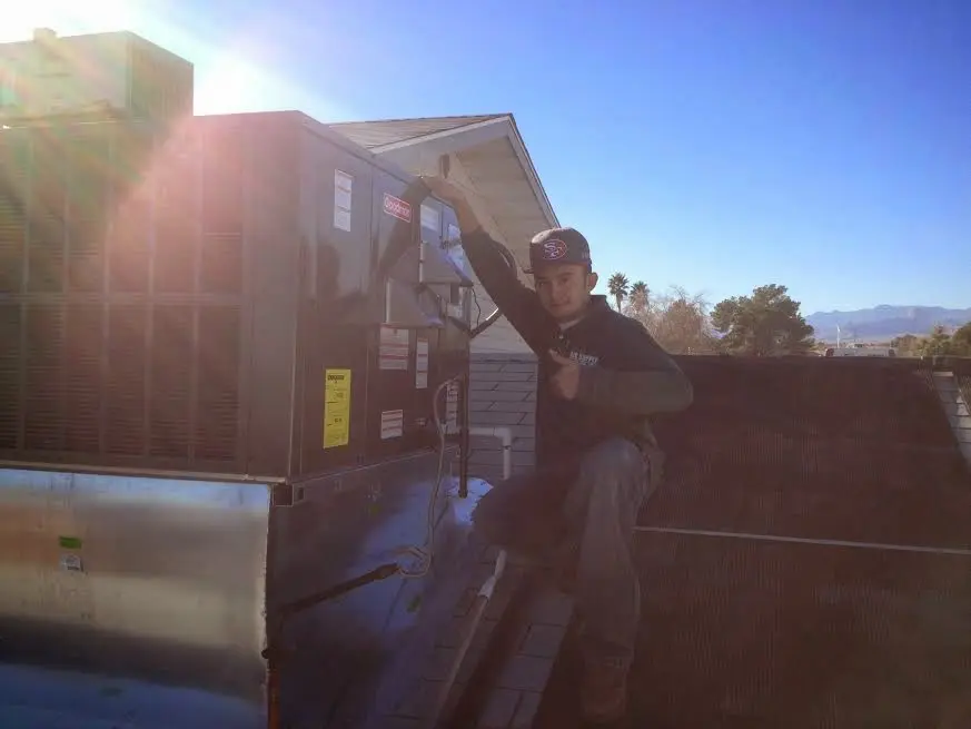 HVAC technician performing Boiler Repair on a rooftop unit in Nazareth